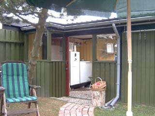 The outdoor kitchen now has a sliding door