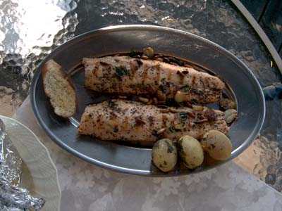 Grilled rainbow trout with toasted pine nuts in garlic olive oil