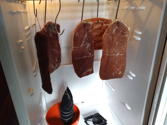 Hams for maturation in the refrigerator.