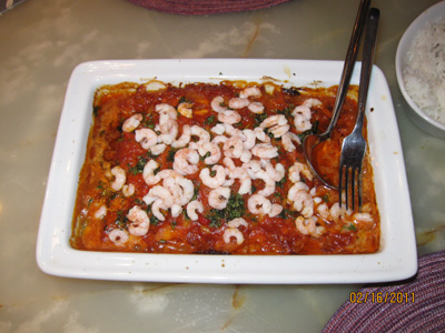 Seithe in a dish in spicy coconut milk with shrimp, rice and herbs