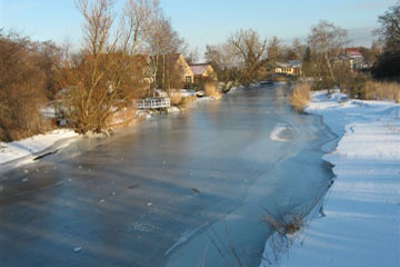 Trygge creek filled with ice in winter at the Prambroen