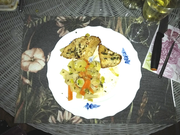 Red fish with vegetables served on a plate
